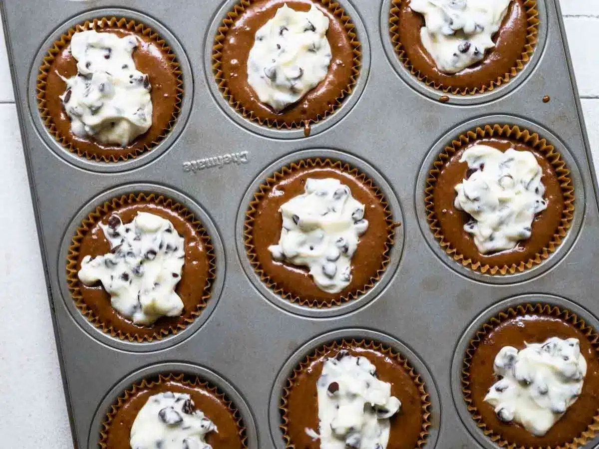 unbaked chocolate dessert circle with cream in the middle in a baking tin
