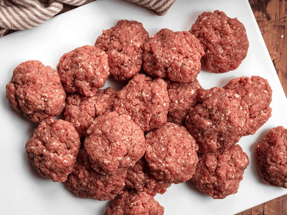 Raw meat patties on a plate ready to be cooked 