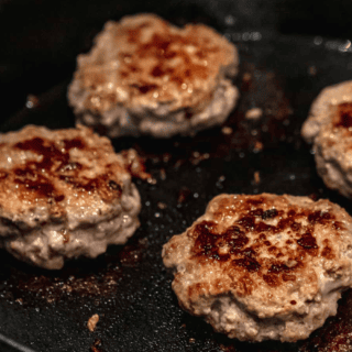 Meat cooking on a cast iron pan
