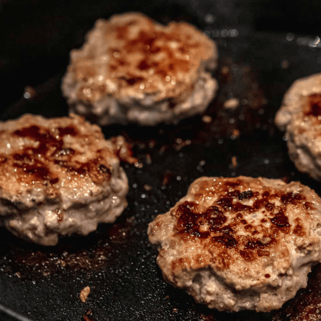 Meat cooking on a cast iron pan