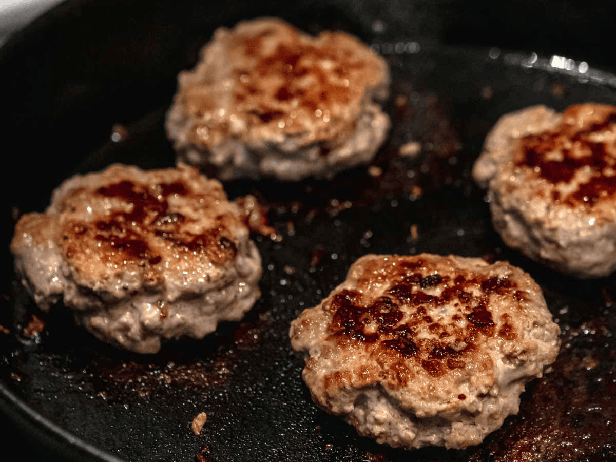 Meat cooking on a cast iron pan 