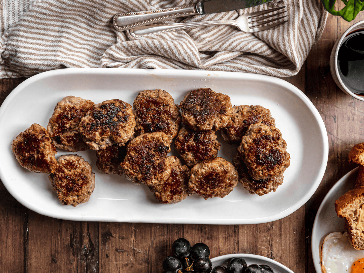 Cooked patties on a white serving plate