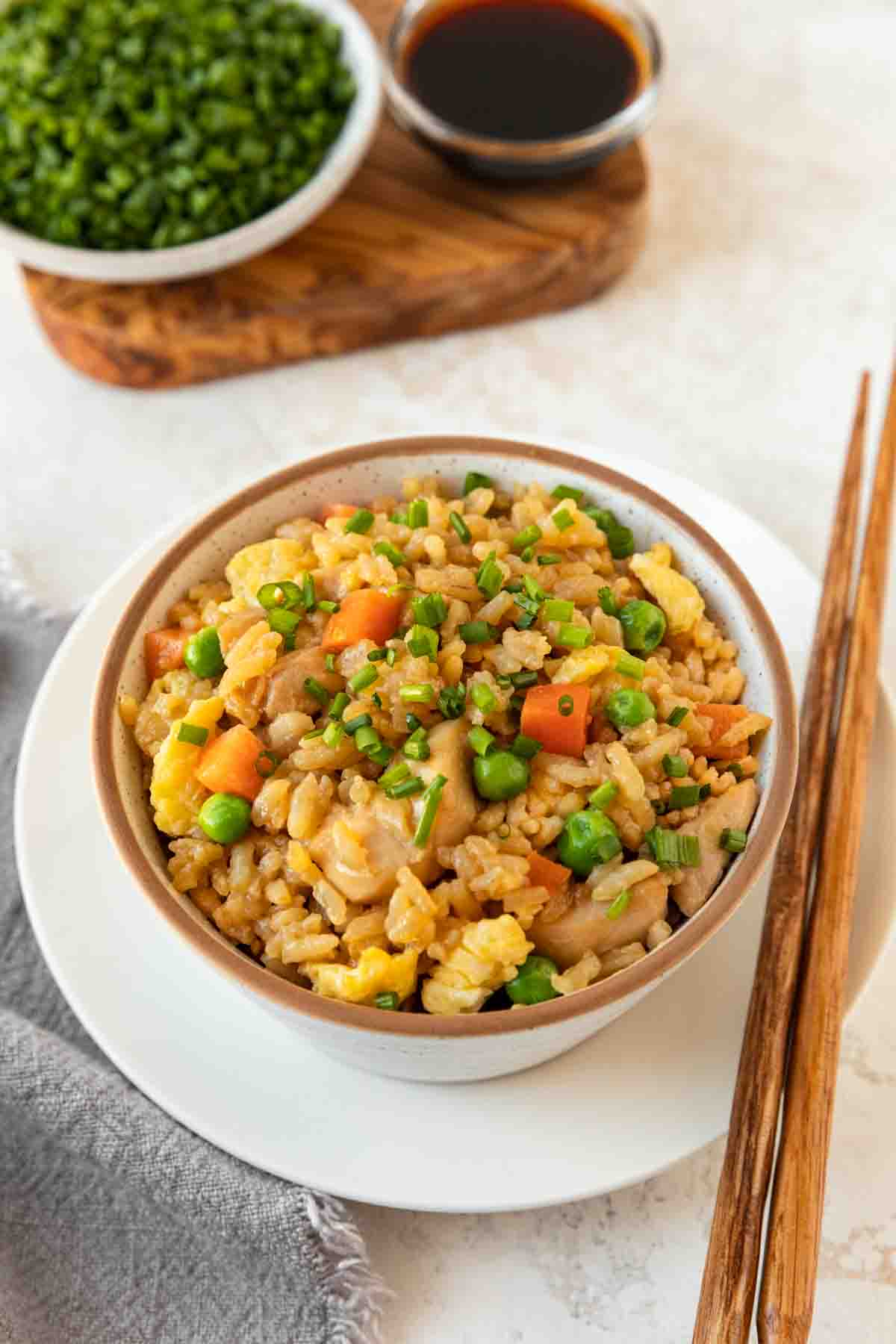 Chicken Fried Rice in bowl with chopsticks on plate