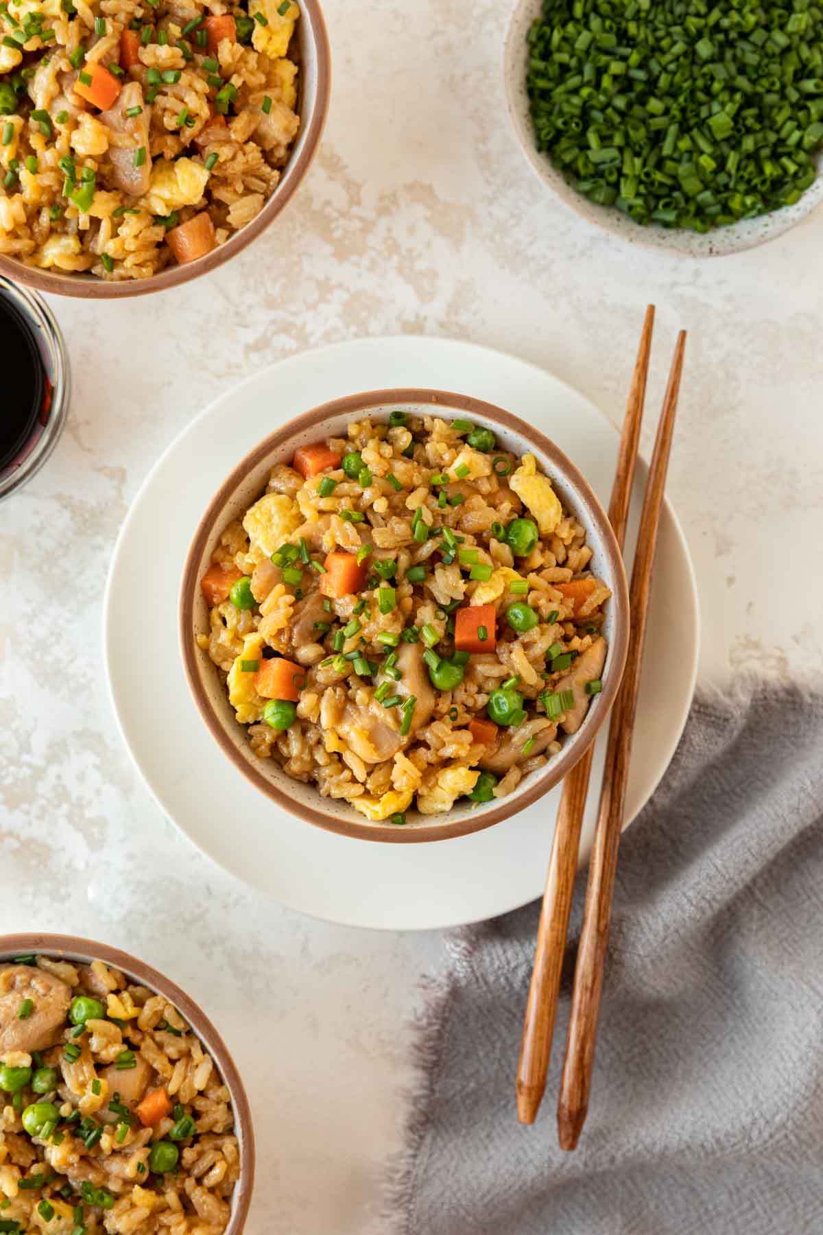 Chicken Fried Rice in bowl with chopsticks on plate