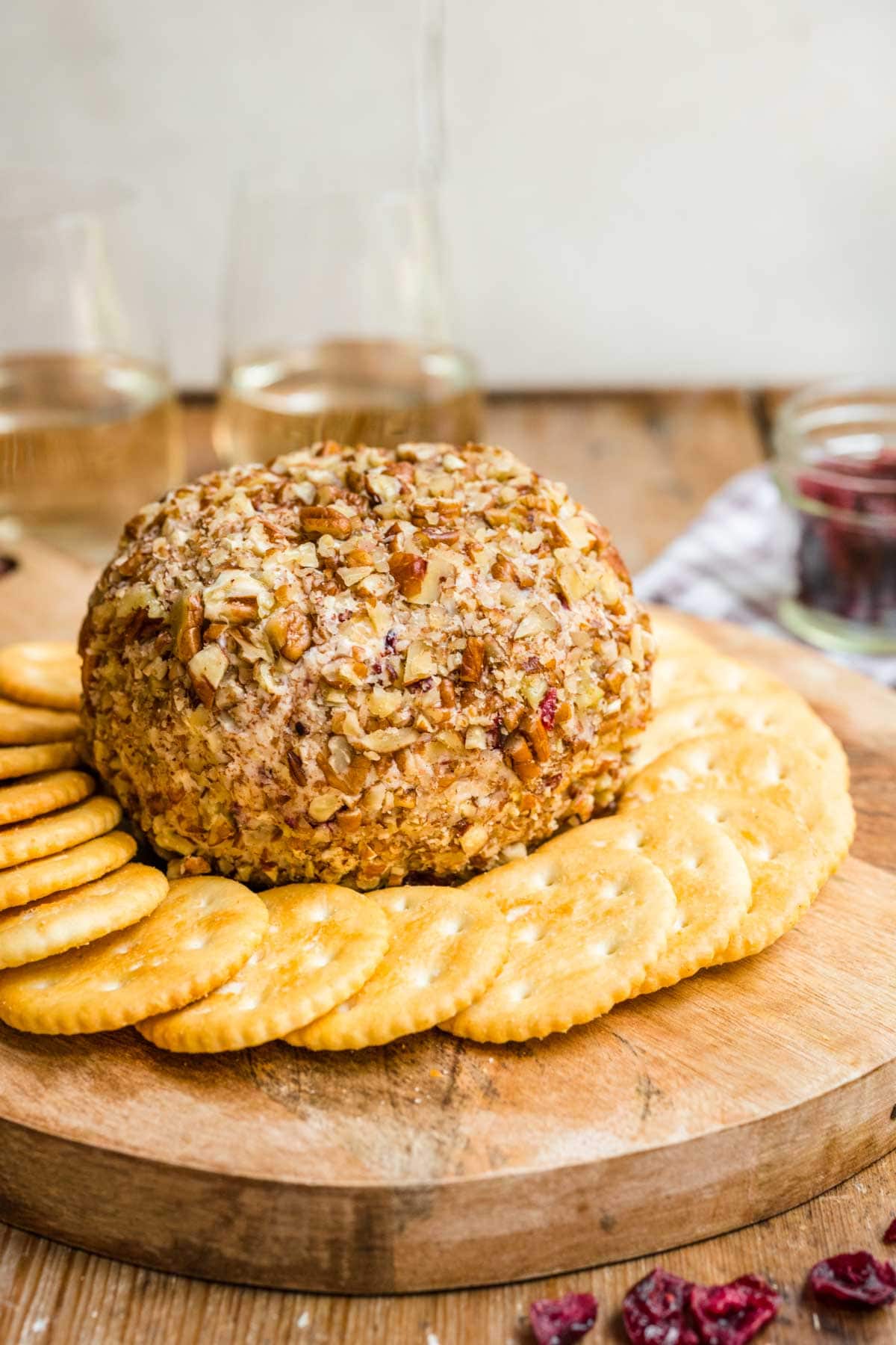 Cranberry Pecan Cheese Ball on serving tray with crackers