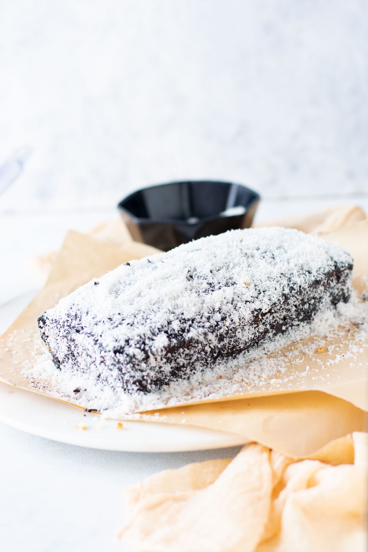 Lamington Loaf Cake frosted and topped on cutting board