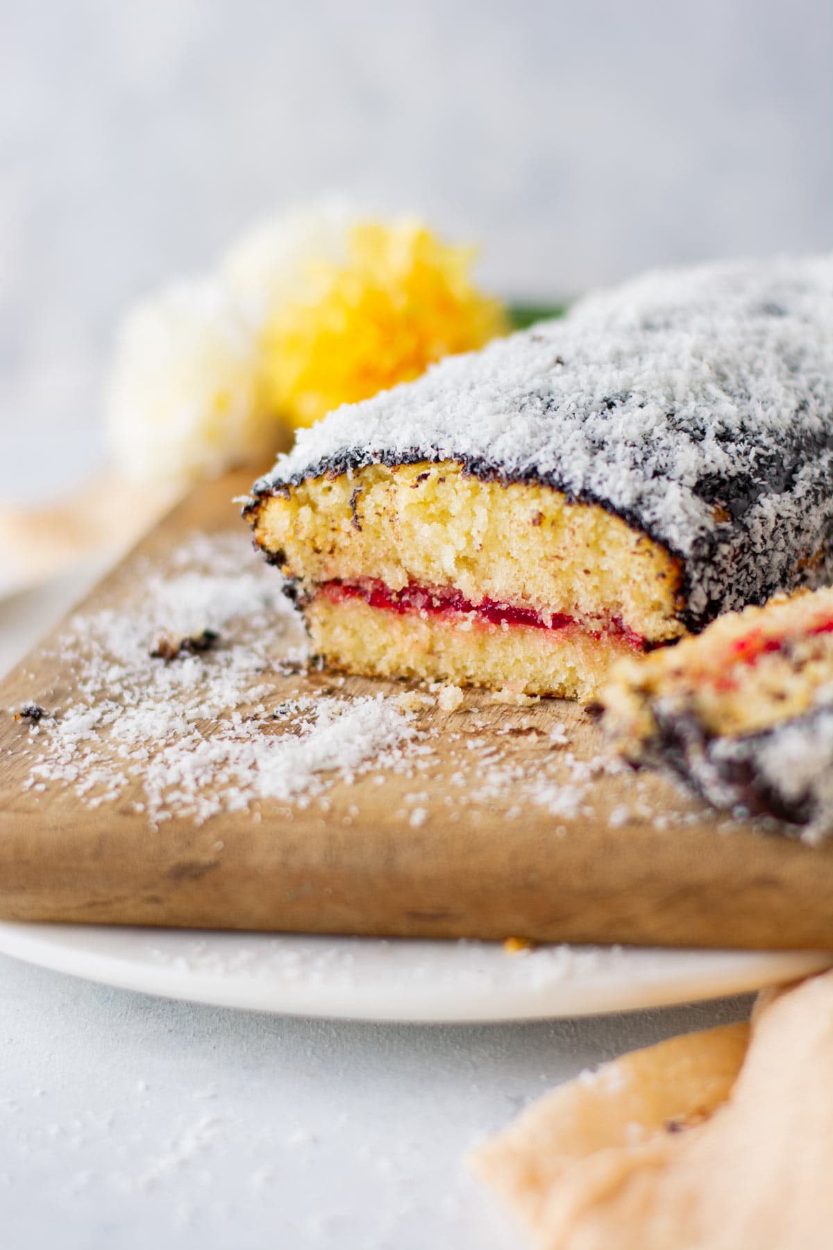 Lamington Loaf Cake sliced open on cutting board