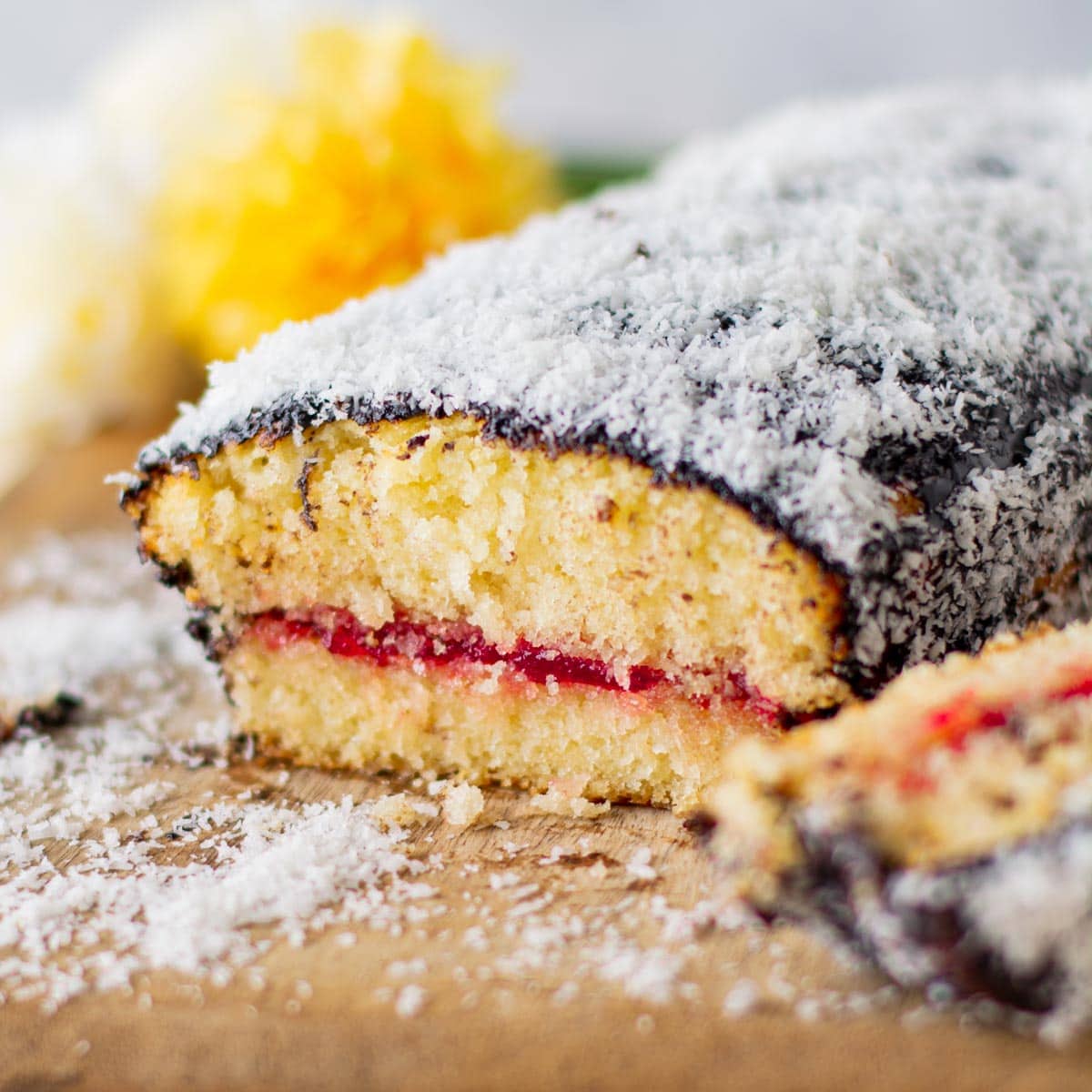 Lamington Loaf Cake sliced open on cutting board