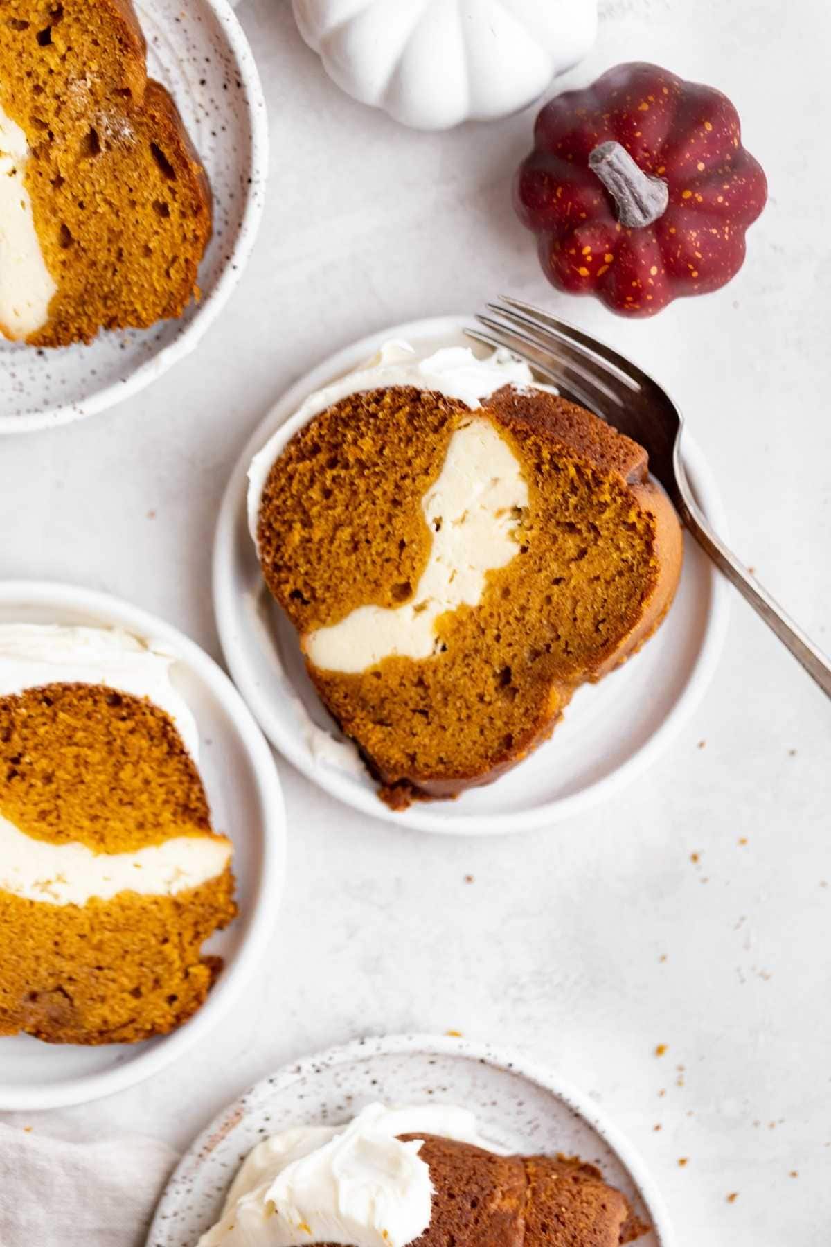 Pumpkin Cheesecake Bundt Cake slices on separate plates