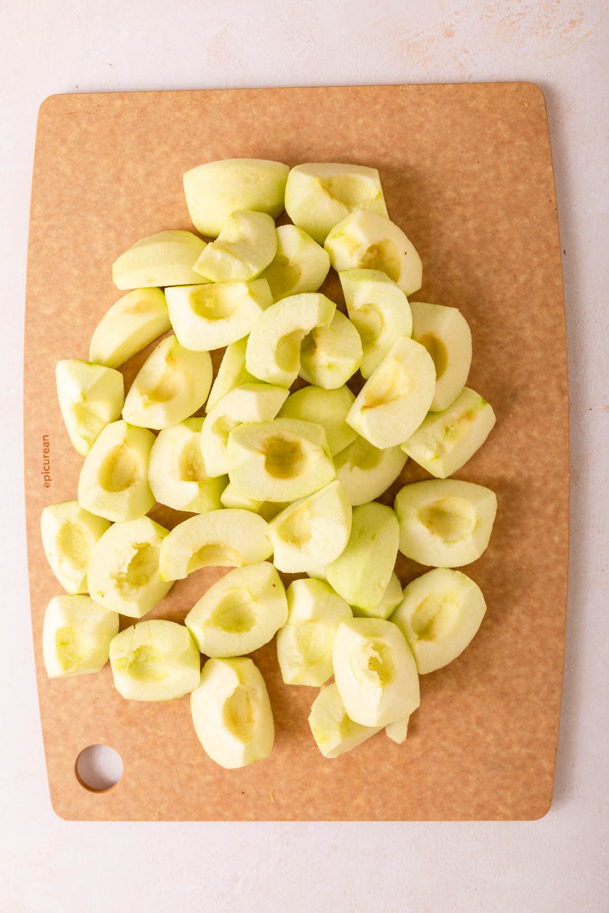 Tarte Tatin peeled and sliced apples on cutting board