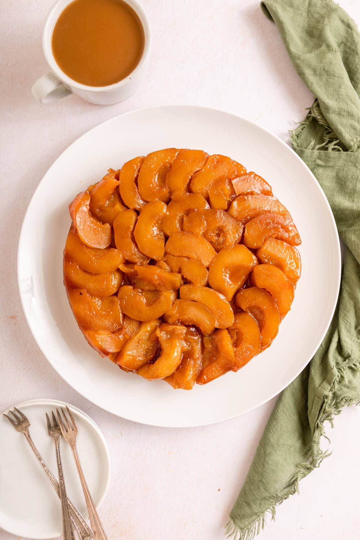 Tarte Tatin baked tart on plate before slicing, top down view