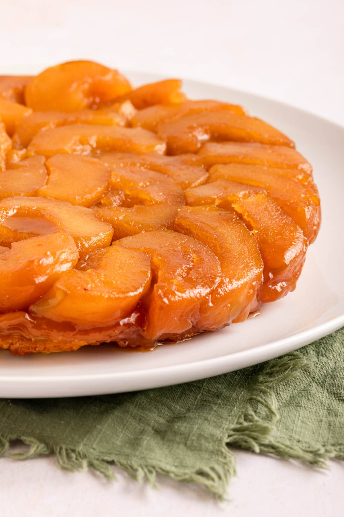 Tarte Tatin baked tart on plate before slicing