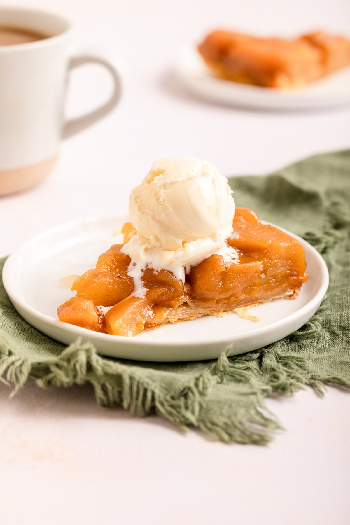 Tarte Tatin baked slice on plate with scoop of vanilla ice cream