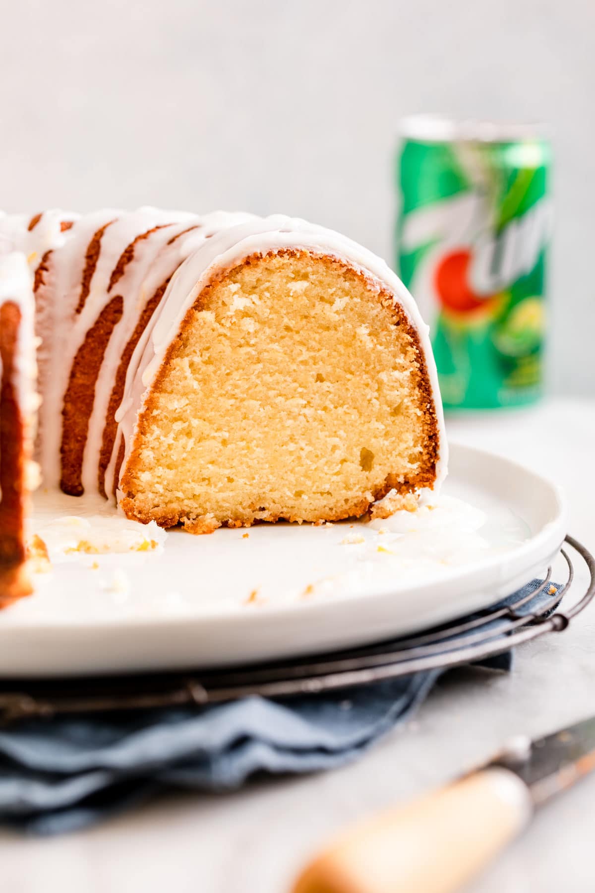 7up Pound Cake baked on plate with glaze side view slice removed