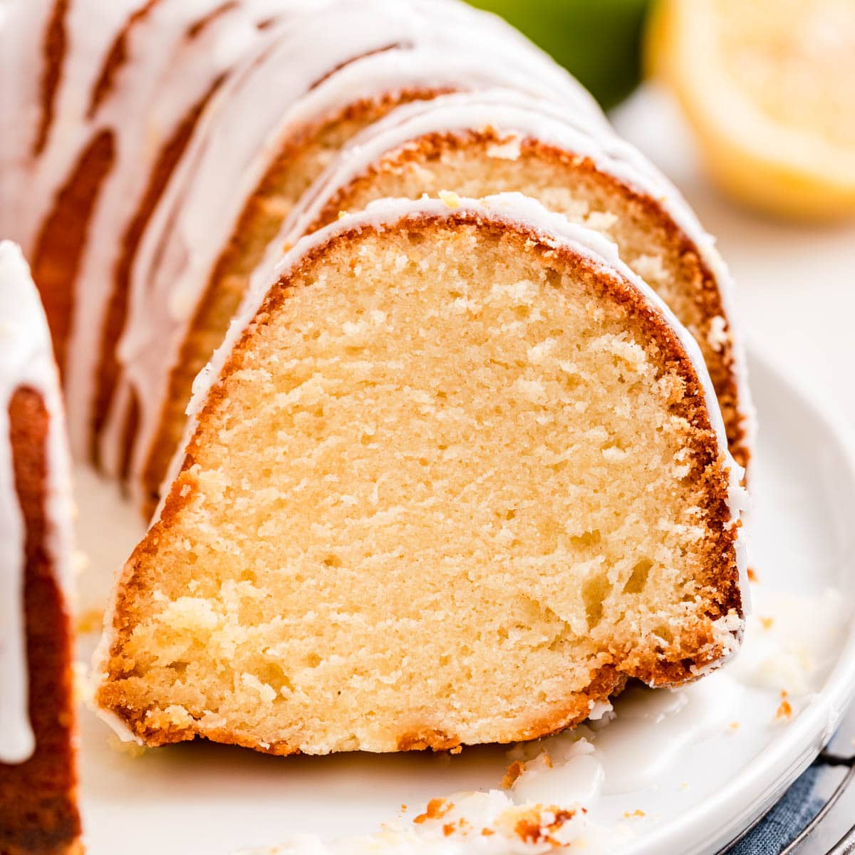 7up Pound Cake baked on plate with glaze side view slice removed