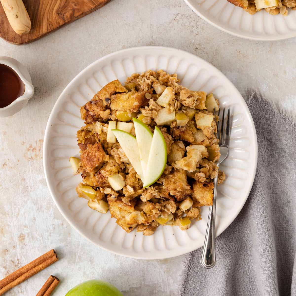 Apple Crisp French Toast Bake serving on a plate with apple slices on top