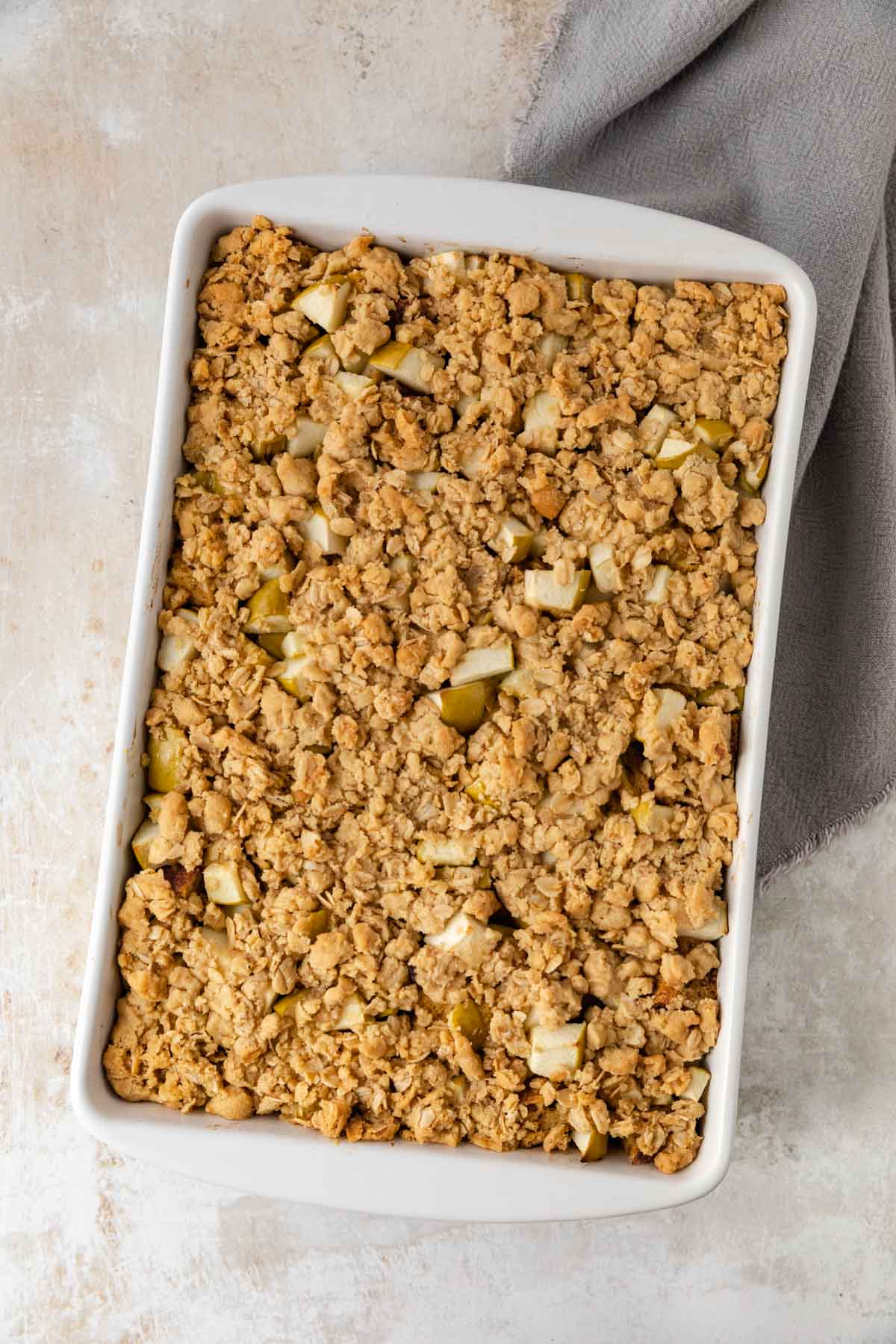 Apple Crisp French Toast Bake assembled in baking dish with topping baked