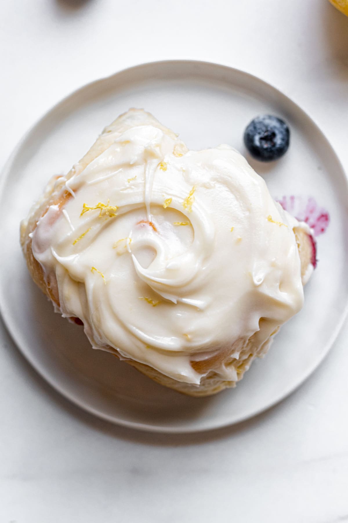 Blueberry Lemon Cinnamon Rolls single roll on plate top view