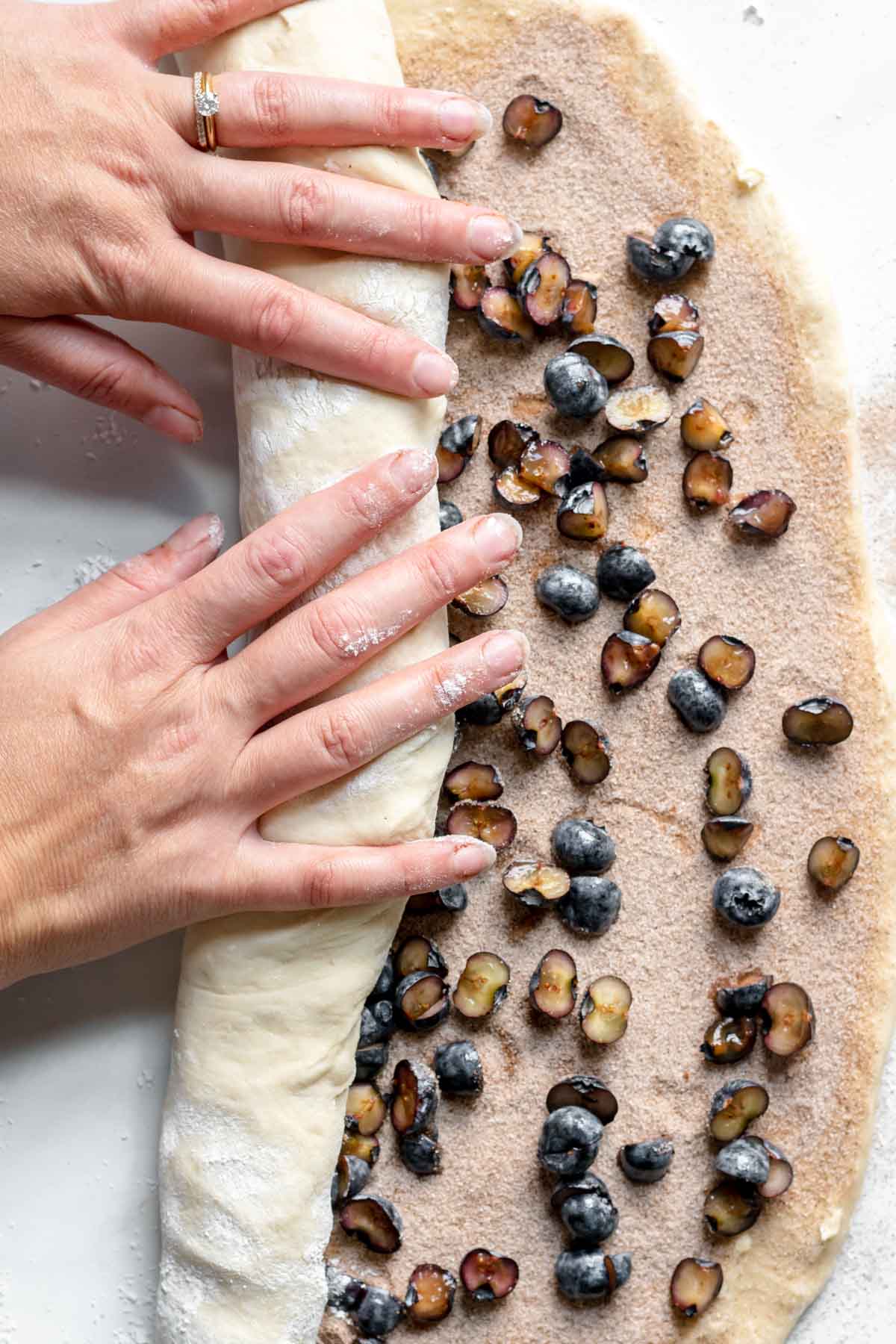 Blueberry Lemon Cinnamon Rolls rolling filled dough