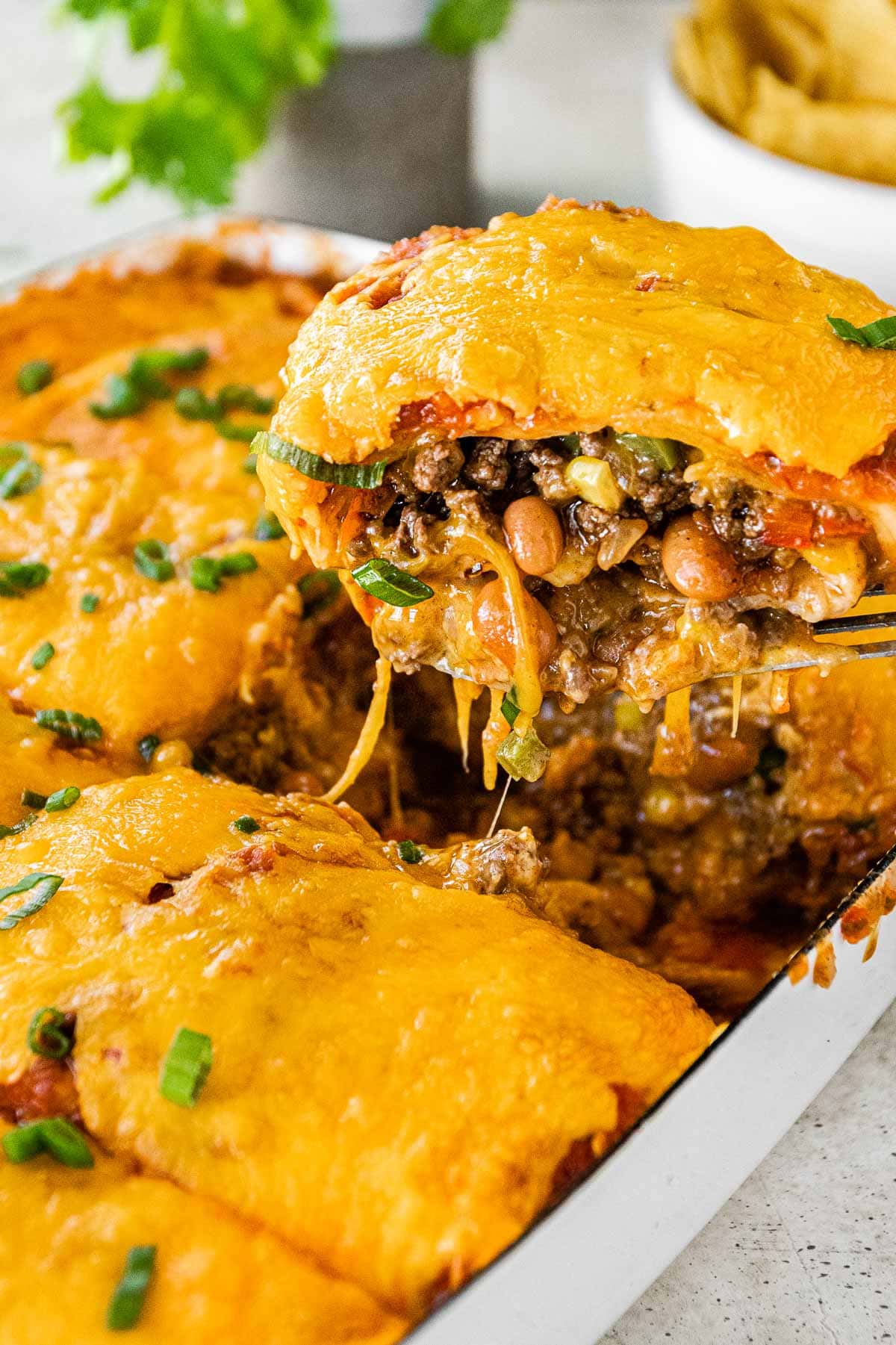 Cheesy Taco Lasagna slice on spatula closeup