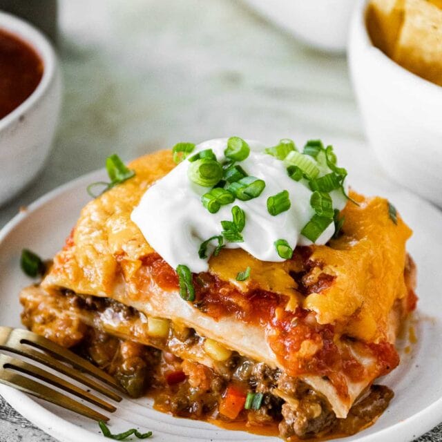 Cheesy Taco Lasagna slice on plate with fork