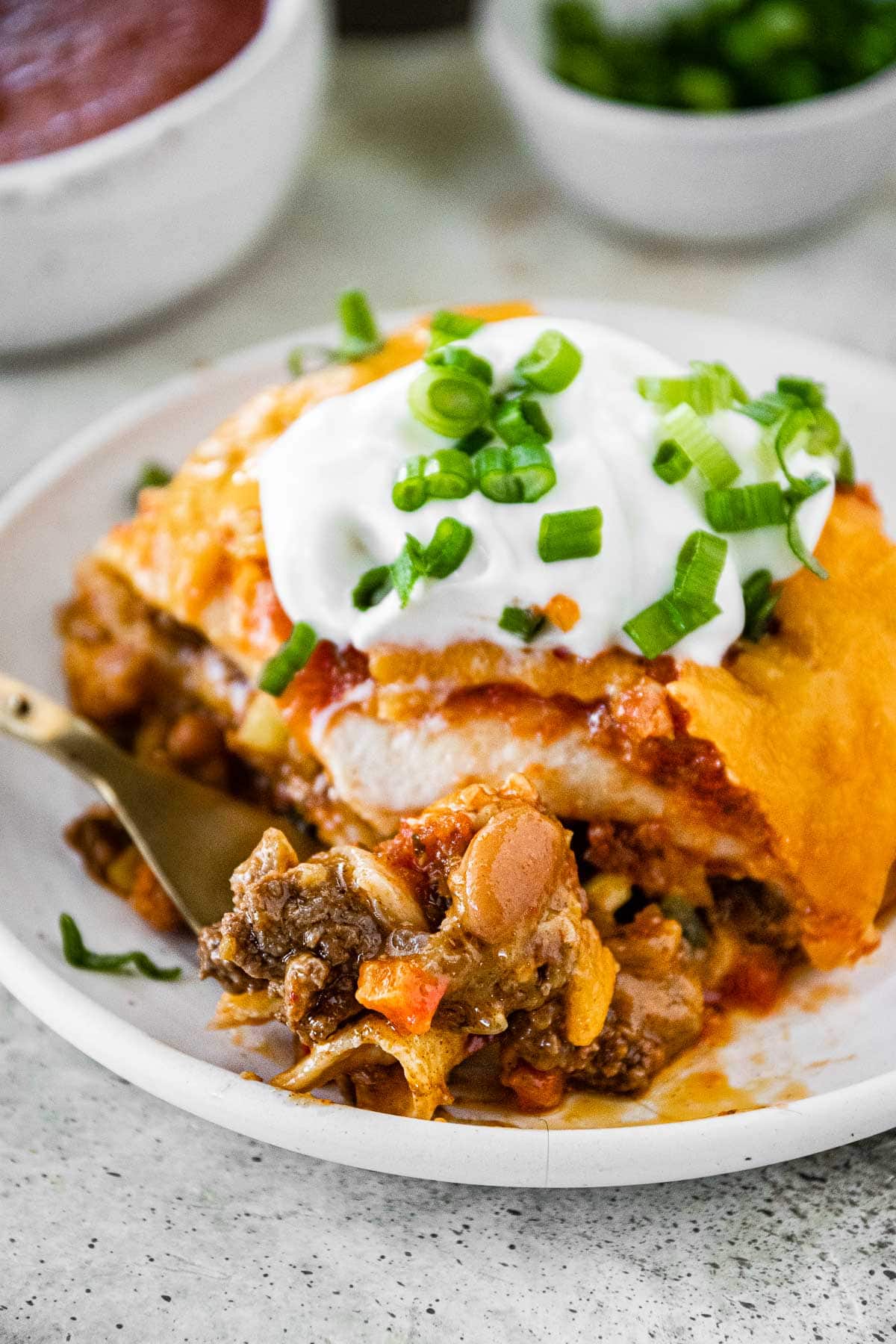 Cheesy Taco Lasagna slice on plate with fork