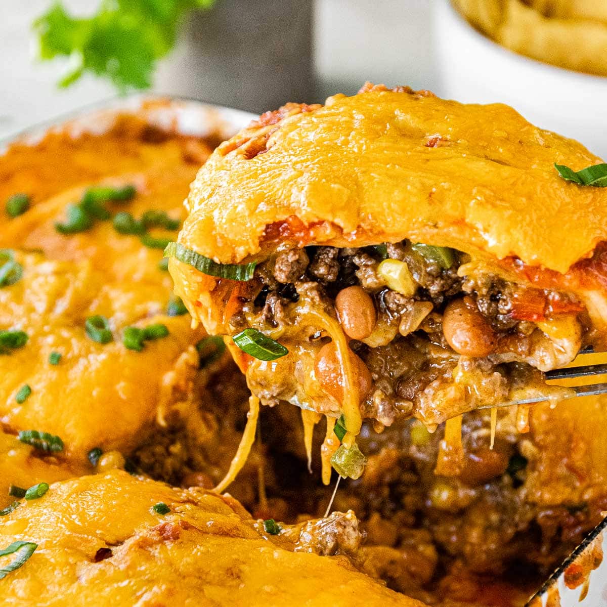 Cheesy Taco Lasagna slice on spatula closeup