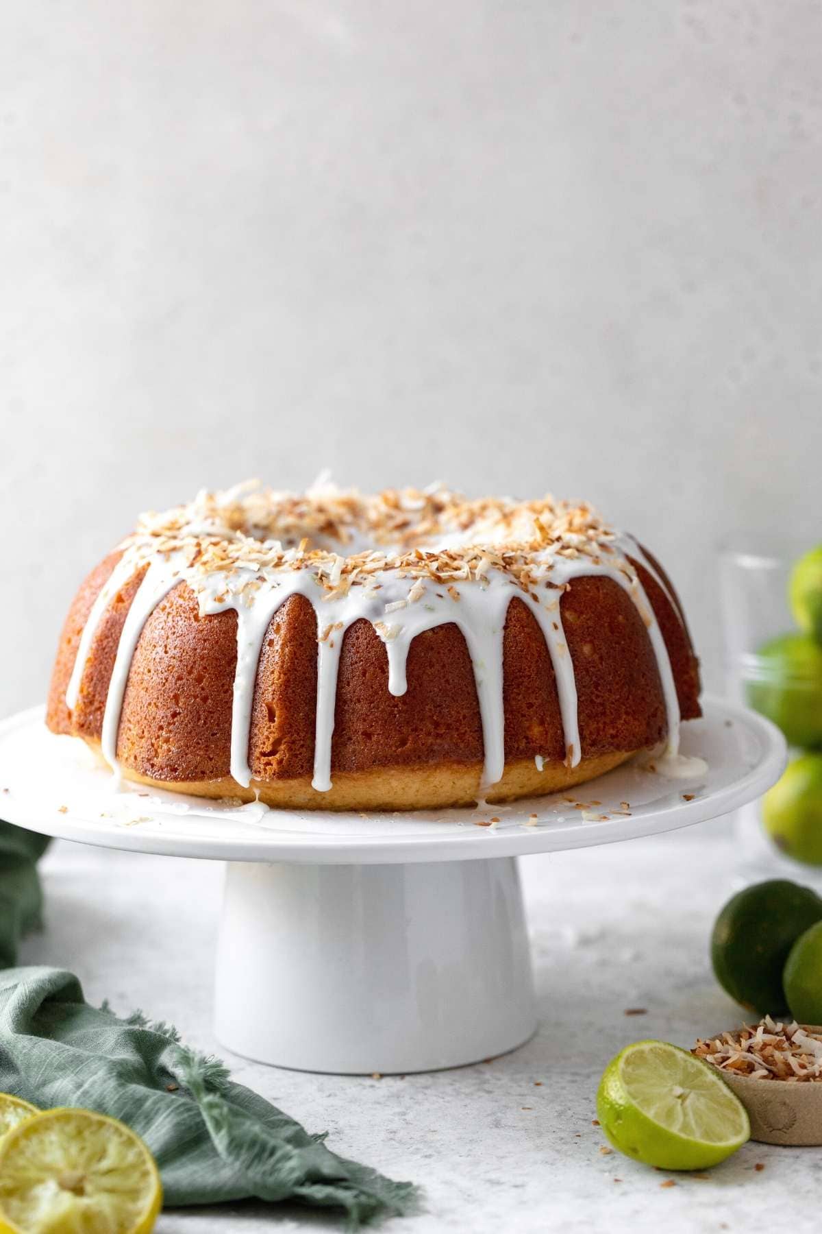 Coconut Lime Bundt Cake on cake stand frosted