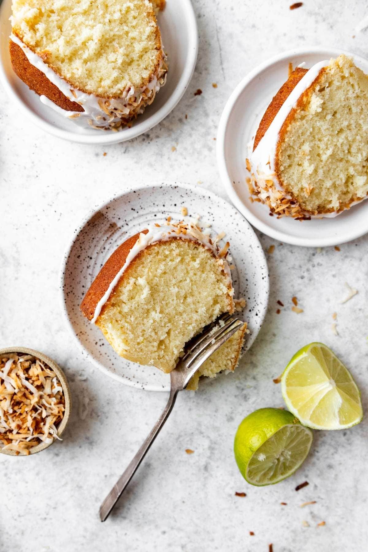 Coconut Lime Bundt Cake slices on plates with fork on center piece