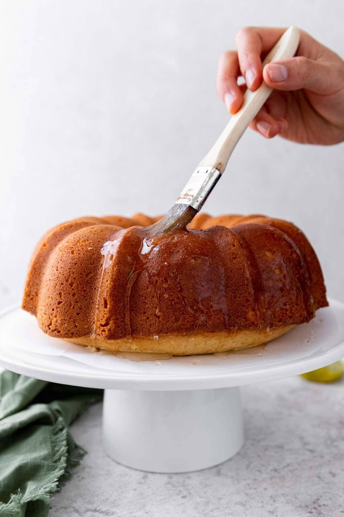 Coconut Lime Bundt Cake on cake stand unfrosted