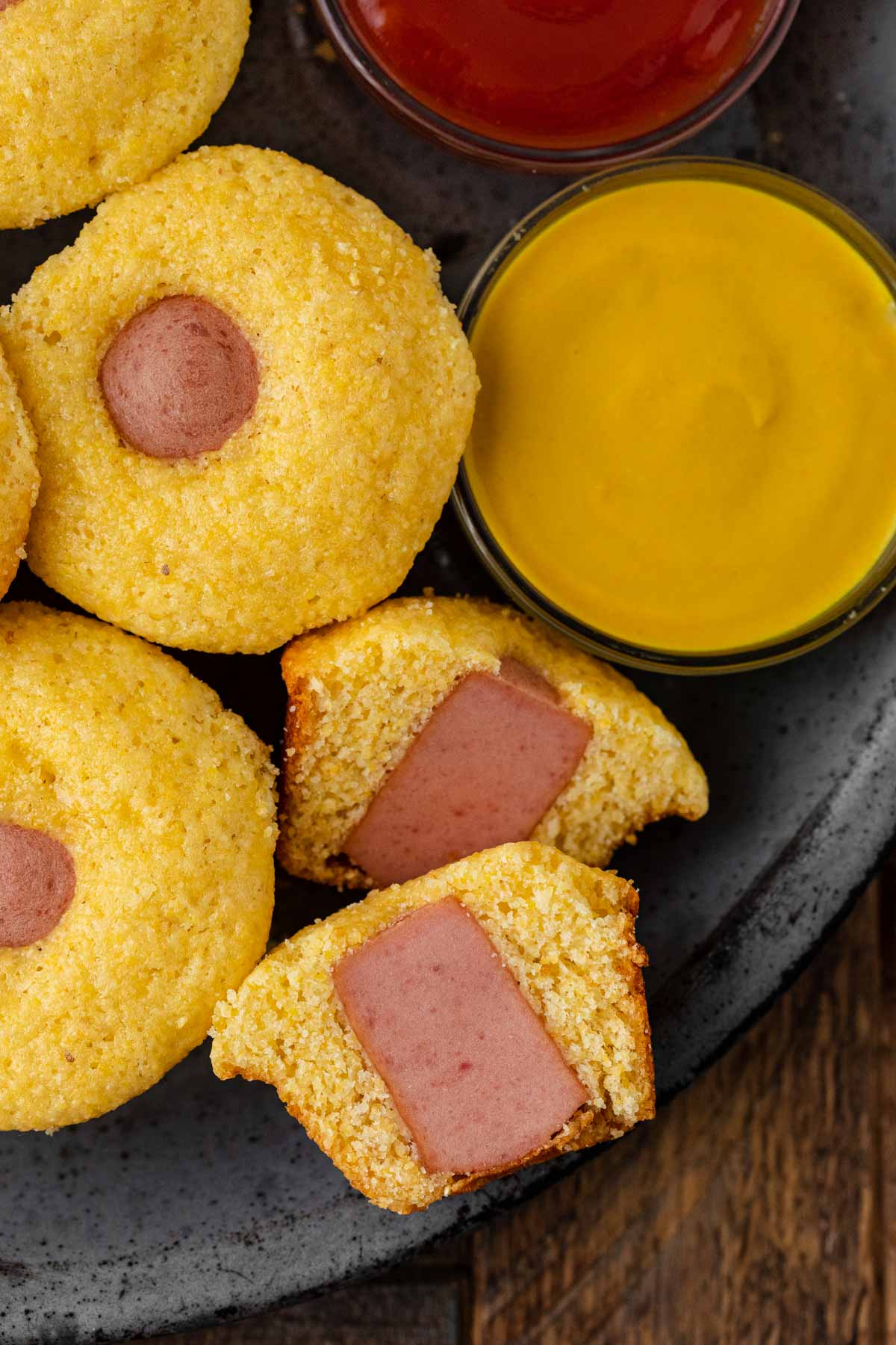 Corndog Mini Muffins with dipping sauces and one sliced in half