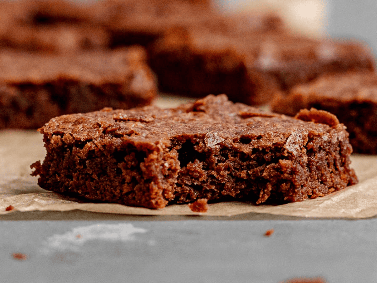 close up of chewy chocolate dessert square with a bite in it