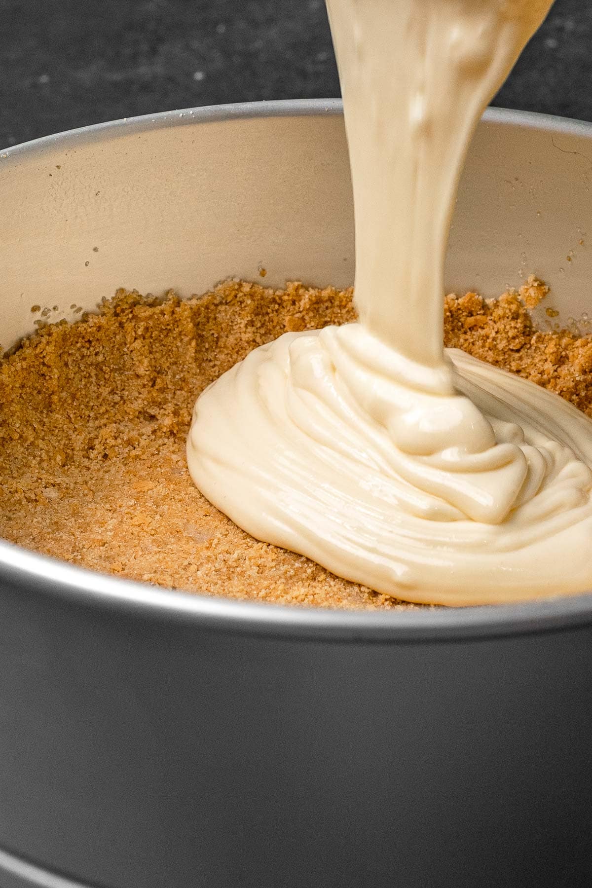 Maple Cheesecake pouring batter into springform pan with crust