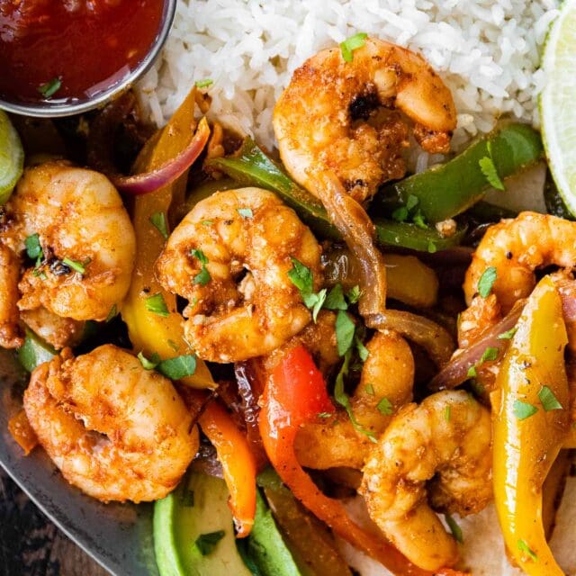 Shrimp Fajitas plated with rice, mostly shrimp and veggies in shot