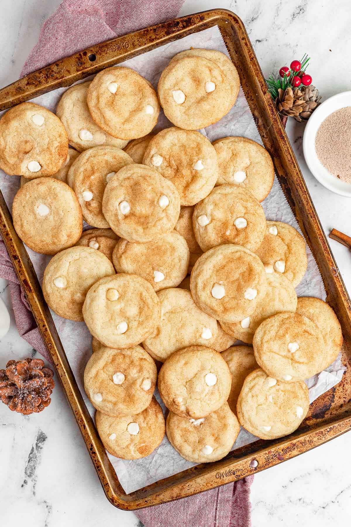 Snickerdoodle Chip Cookies stacked on baking pan