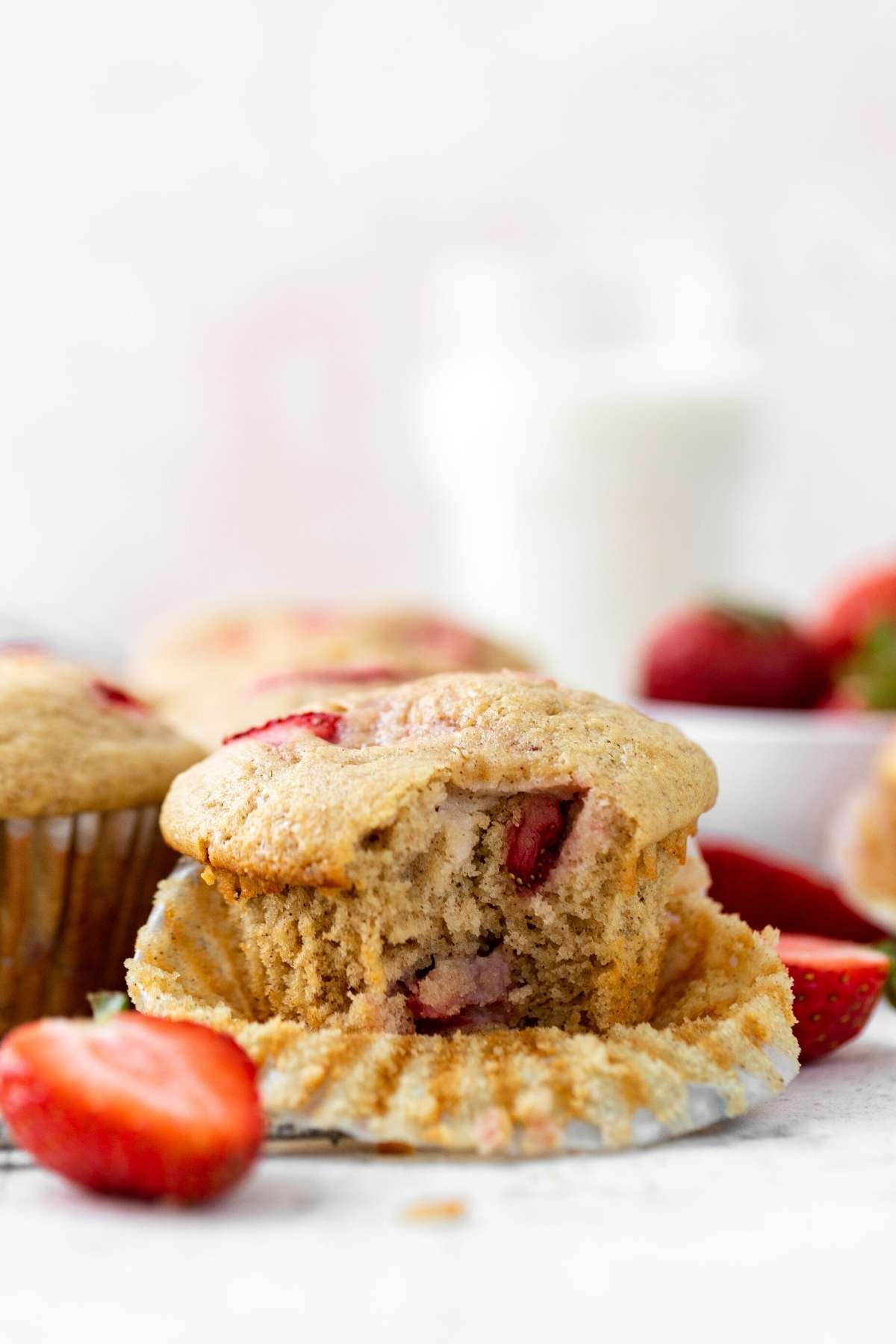 Strawberry Muffins with liner open and bite taken