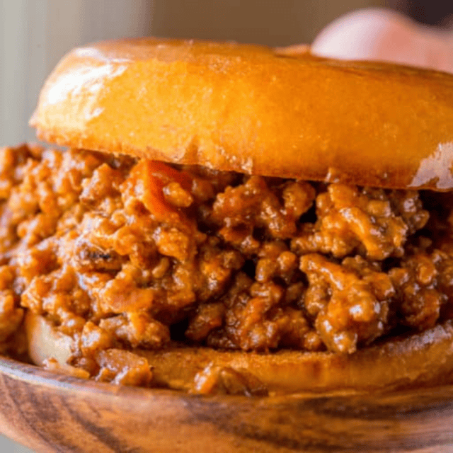 sloppy Joe sandwich on wood plate
