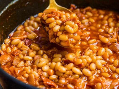 spoon scooping beans over a pot