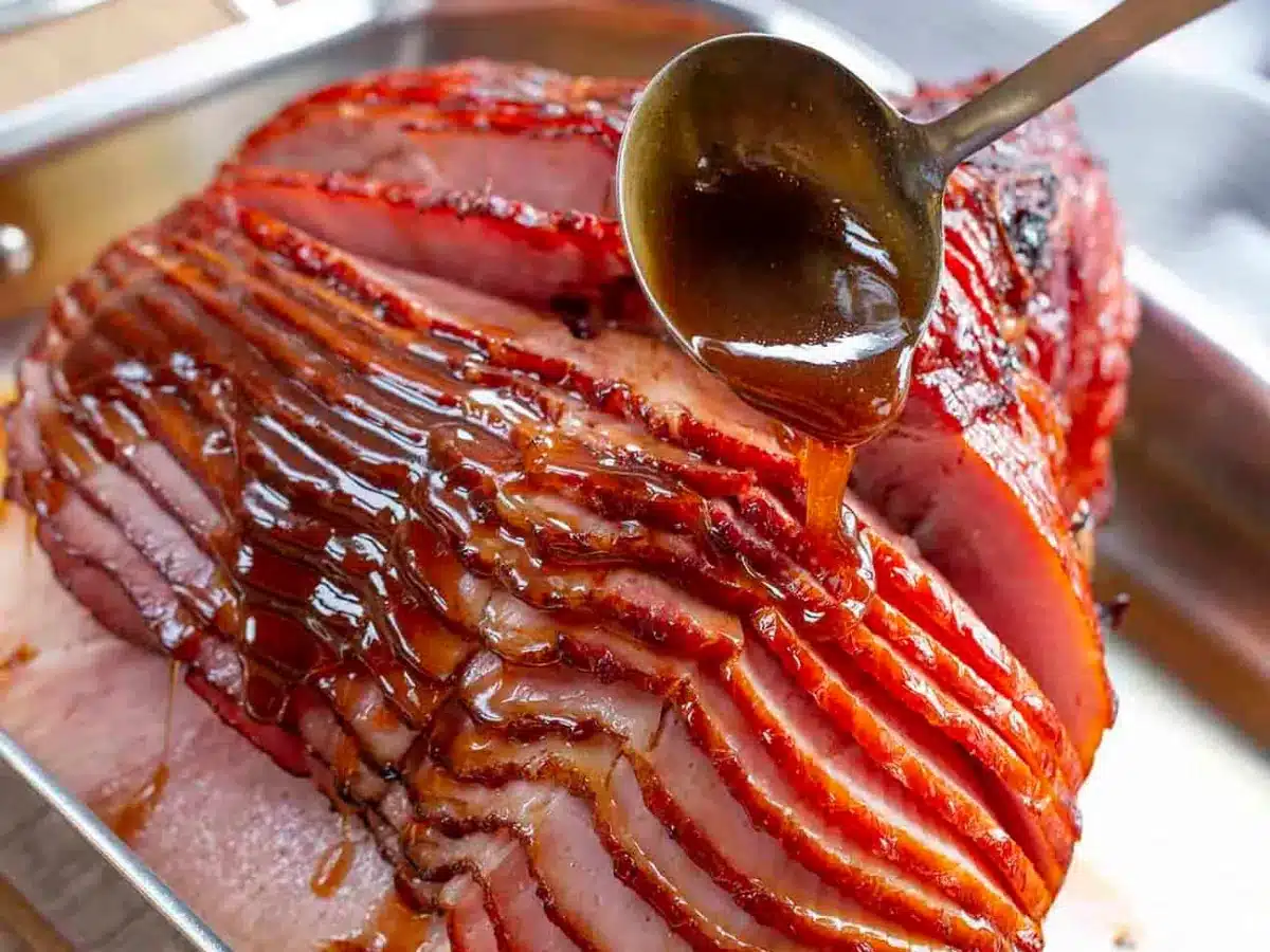 glaze being spooned over ham 