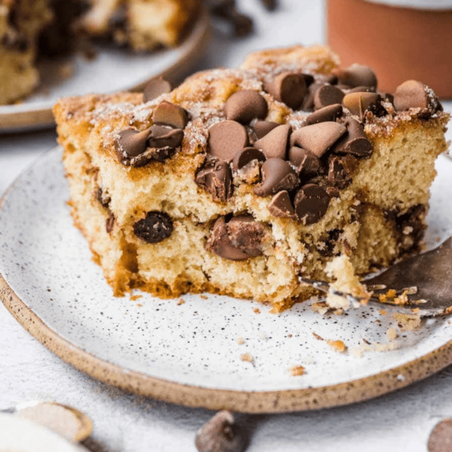 slice of cake on a plate with a bite taken