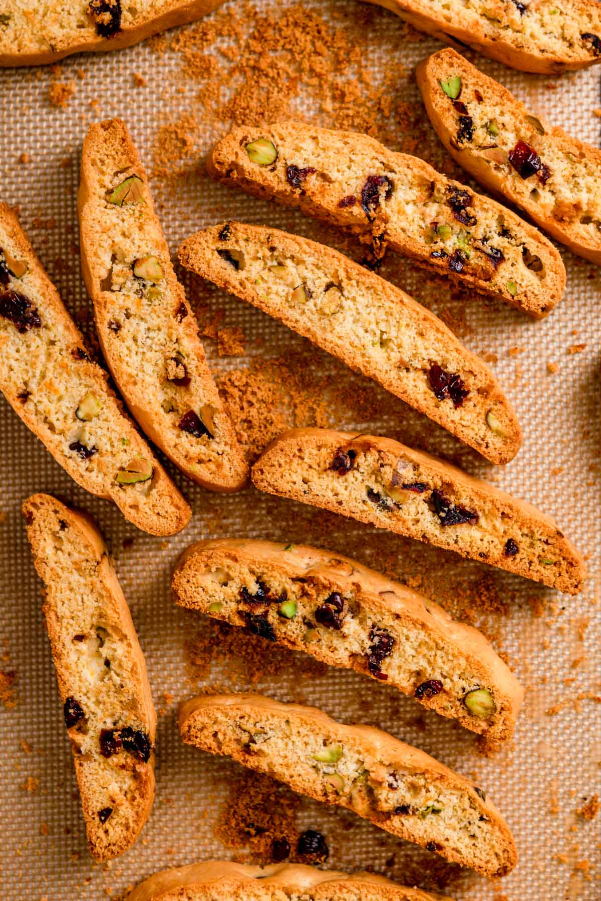 Christmas Pistachio Cranberry Biscotti dough sliced and baked on a pan