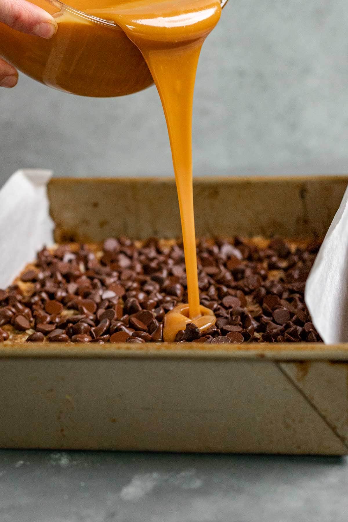 Easy Caramel Sauce being poured over brownies