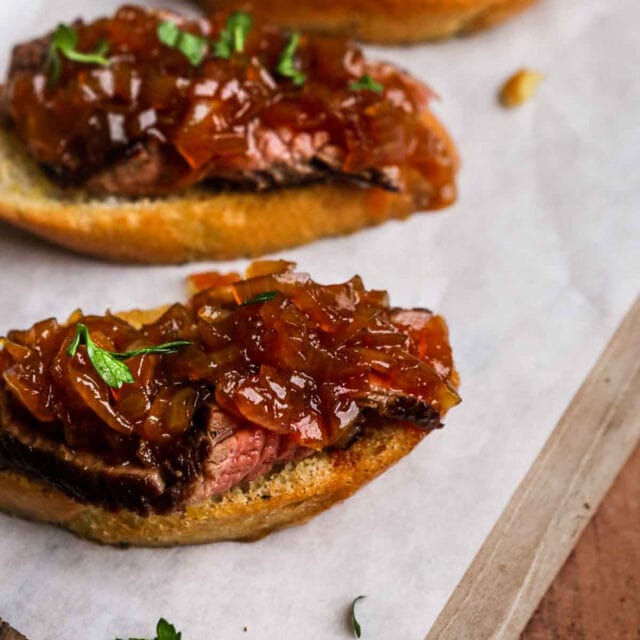 Onion Jam spread on steak on baguette slices