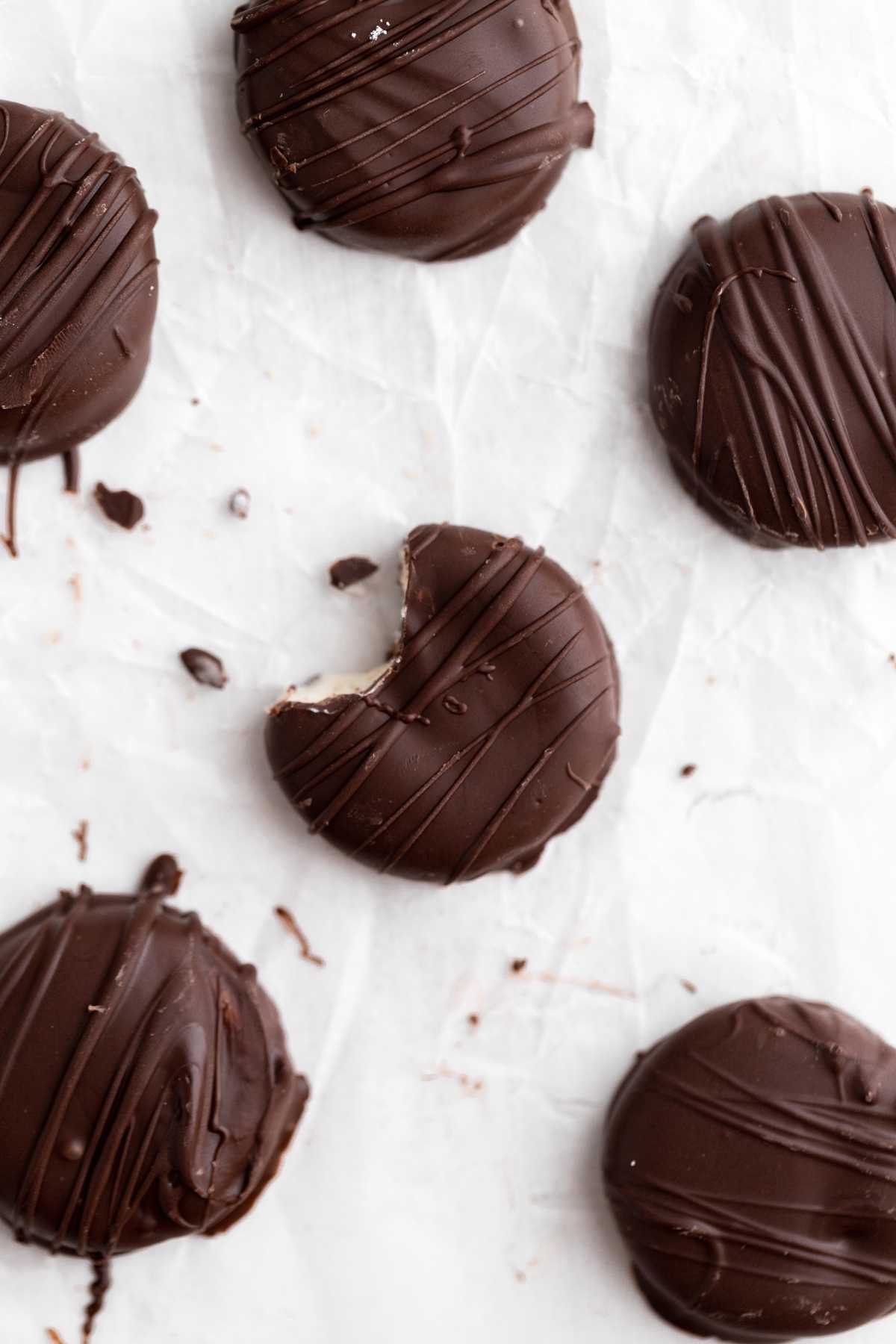 Peppermint Patties on parchment with bite taken from one