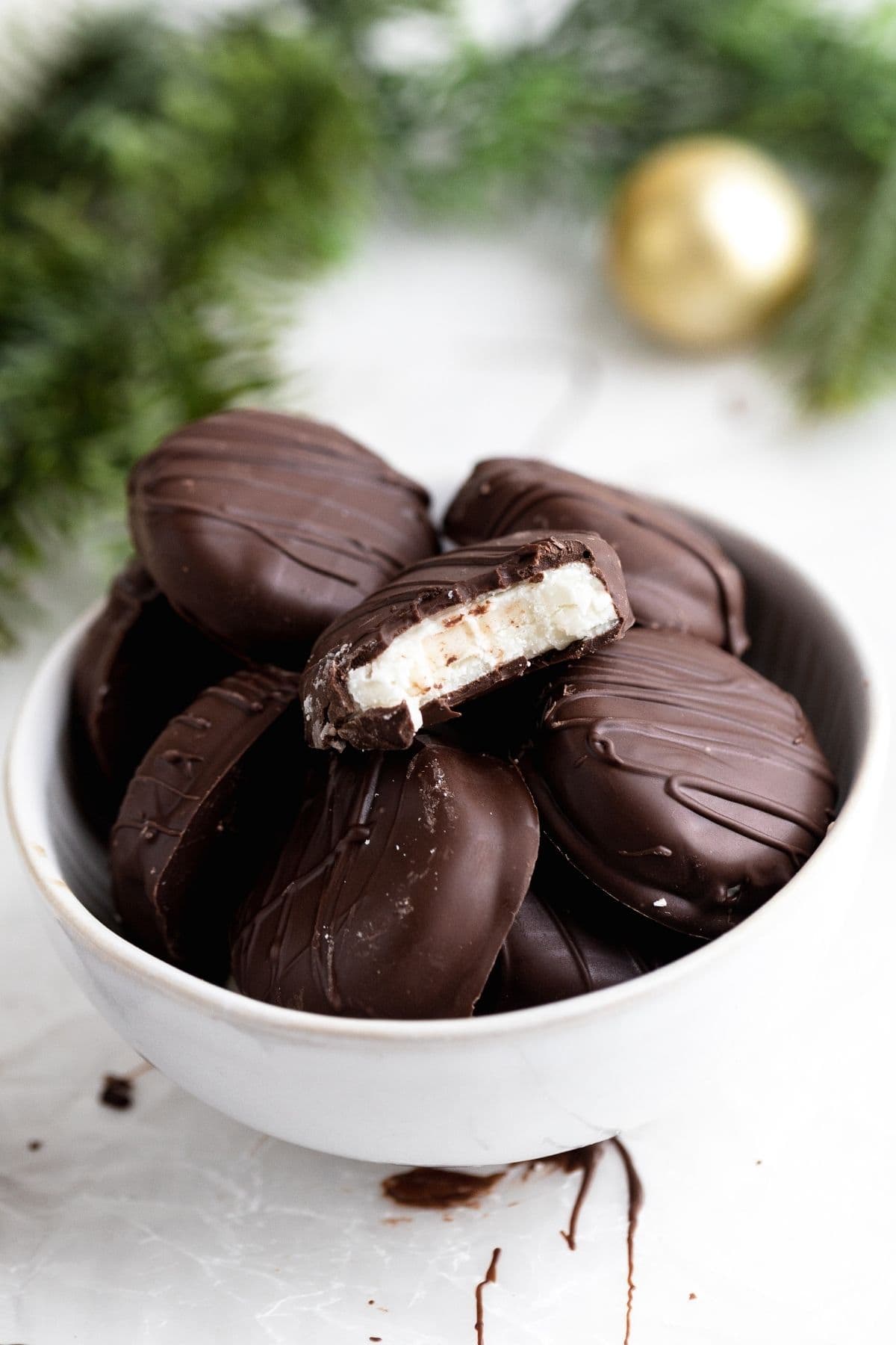 Peppermint Patties in serving bowl with bite taken from one