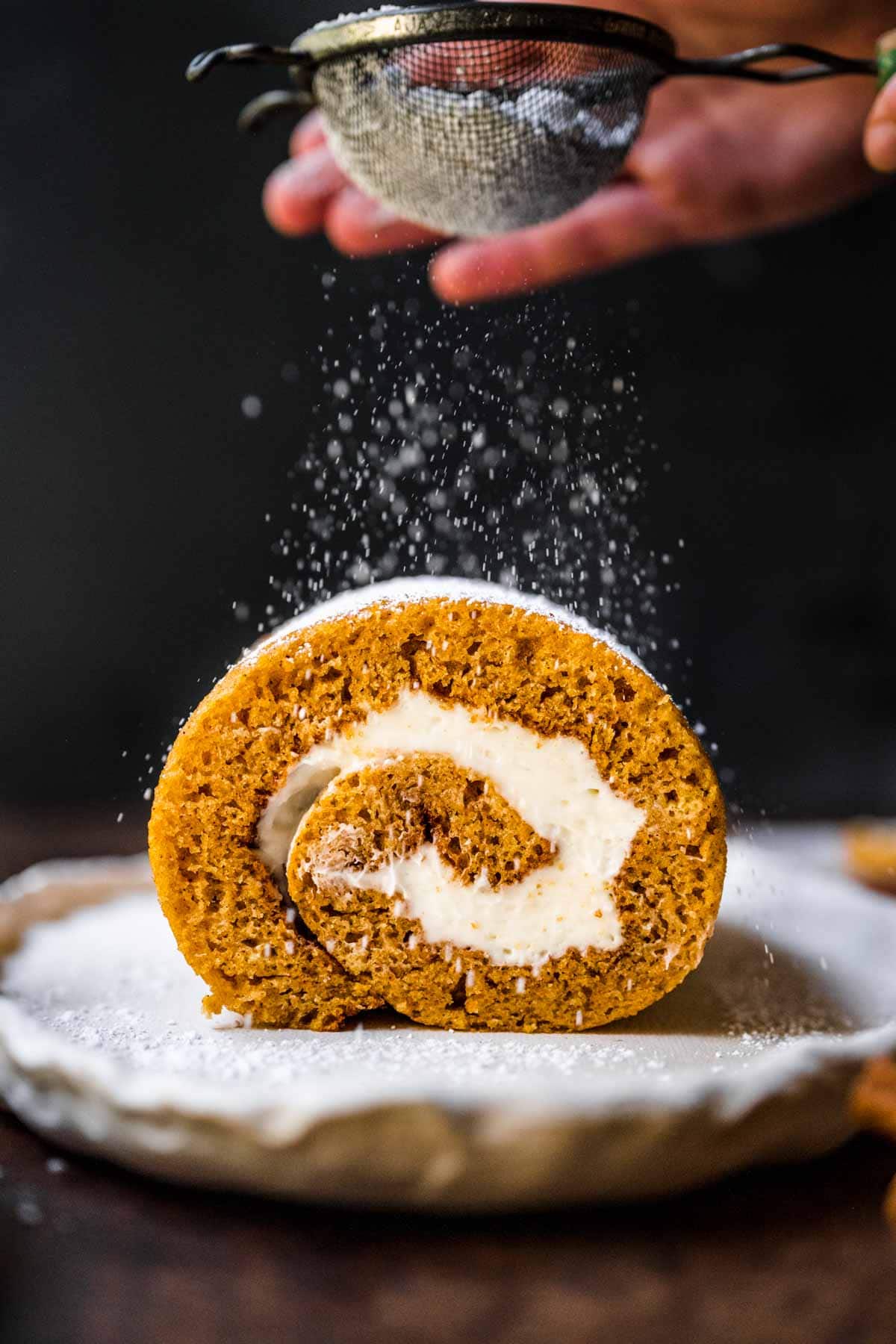 Pumpkin Roll dusting with powdered sugar