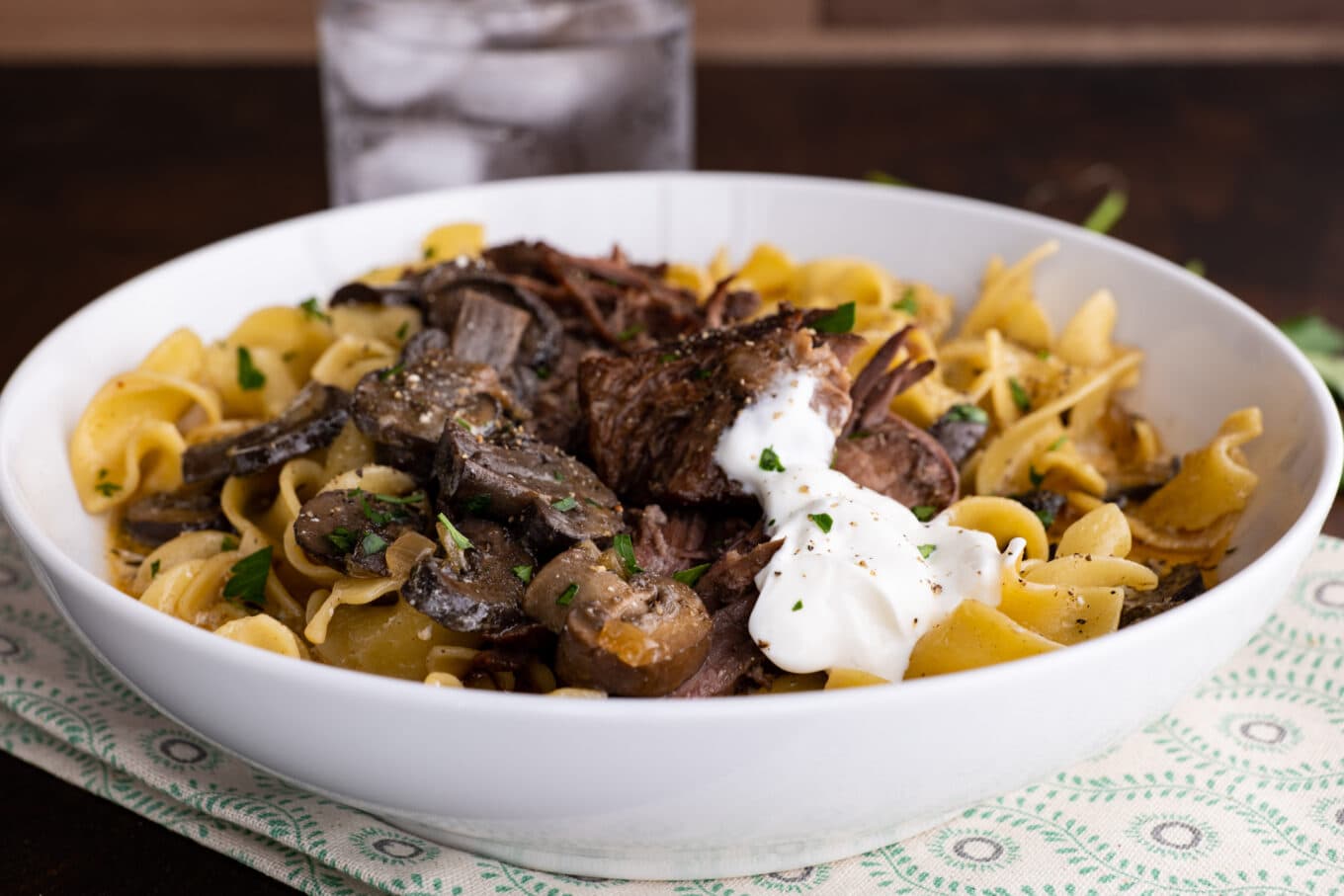 Slow Cooker Pot Roast Beef Stroganoff in a bowl with noodles