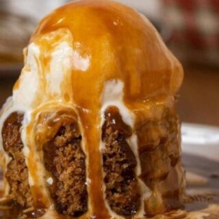 pudding on a white plate with a scoop of ice cream.