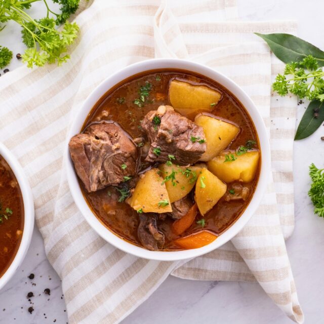 White bowl of stew on a cloth