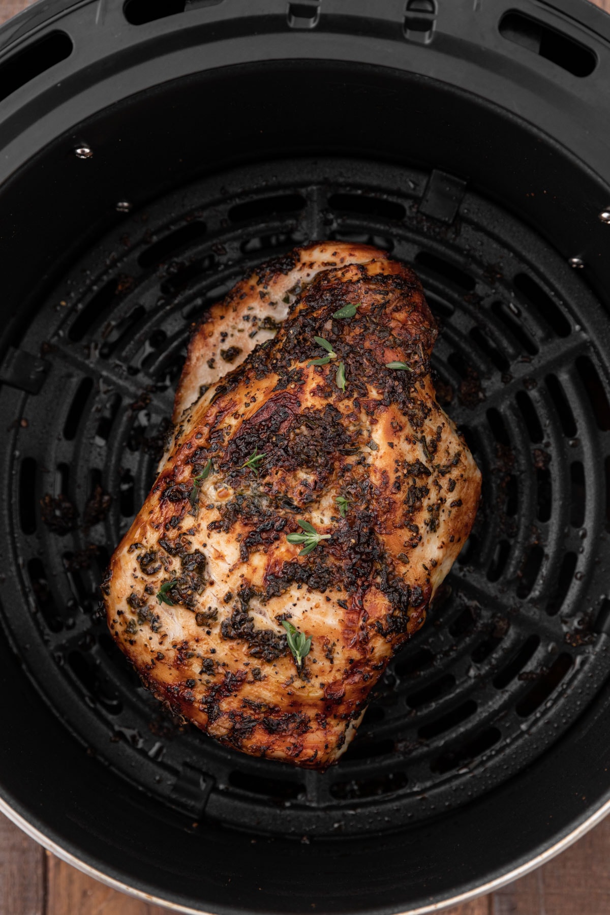 Air Fryer Herb Butter Turkey Breast fully cooked in air fryer basket